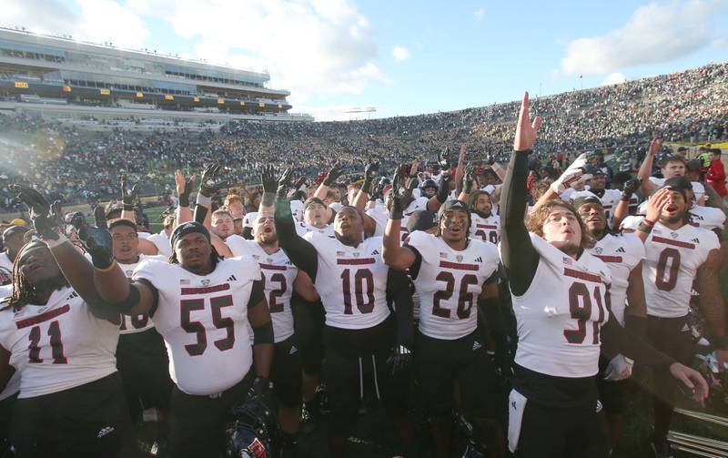 Members of the NIU football team celebrate after beating Notre Dame on Saturday, Sept. 7, 2024 at Notre Dame Stadium.