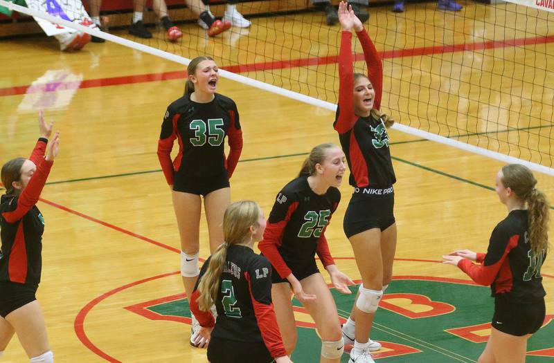 Members of the L-P volleyball team celebrate after defeating Geneseo in the Class 3A Regional on Tuesday, Oct. 24, 2023 at Sellett Gymnasium.