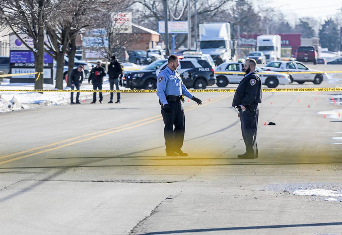 Police secure the scene of a shooting Friday, along Republic Avenue in Joliet.