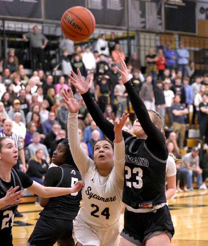 Sycamore's Monroe McGhee and Kaneland's Kendra Brown go after a loose ball during their Class 3A sectional semifinal Tuesday, Feb. 20, 2024, at Sycamore High School.
