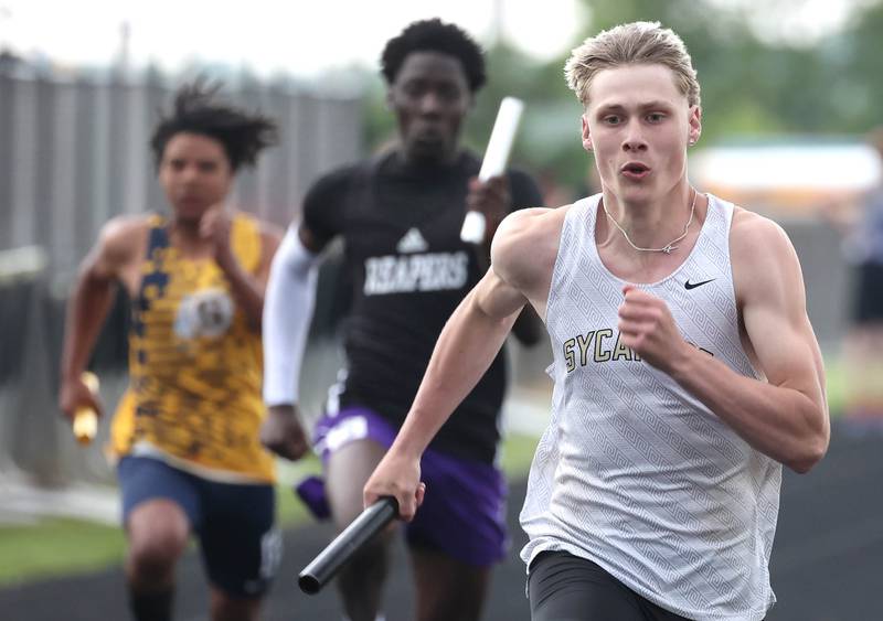 Sycamore’s Aidan Wyzard runs the anchor leg of the 4x100 meter relay Thursday, May 16, 2024, during the Class 2A boys track sectional at Sycamore High School.