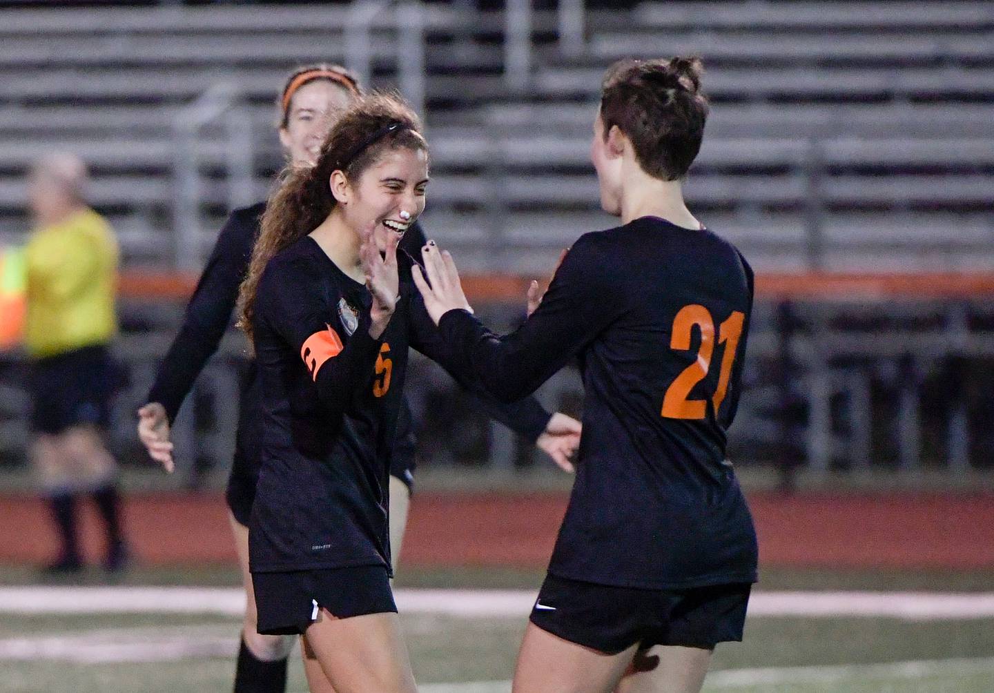 St. Charles East's Yazmin Martinez, left, celebrates her goal, kicked from the 40 yard line, with Kara Machala (21) during a game on Tuesday, March 15, 2022.