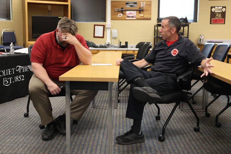 Mental Health Coordinator John Lukancic, left, portrays a traumatized citizen while firefighter/paramedic Neil Abbott consoles him during a role-play scenario at the Crisis First Aid refresher course for the Joliet Fire Department Station One crew on Wednesday, July 12th, 2023 in Joliet.