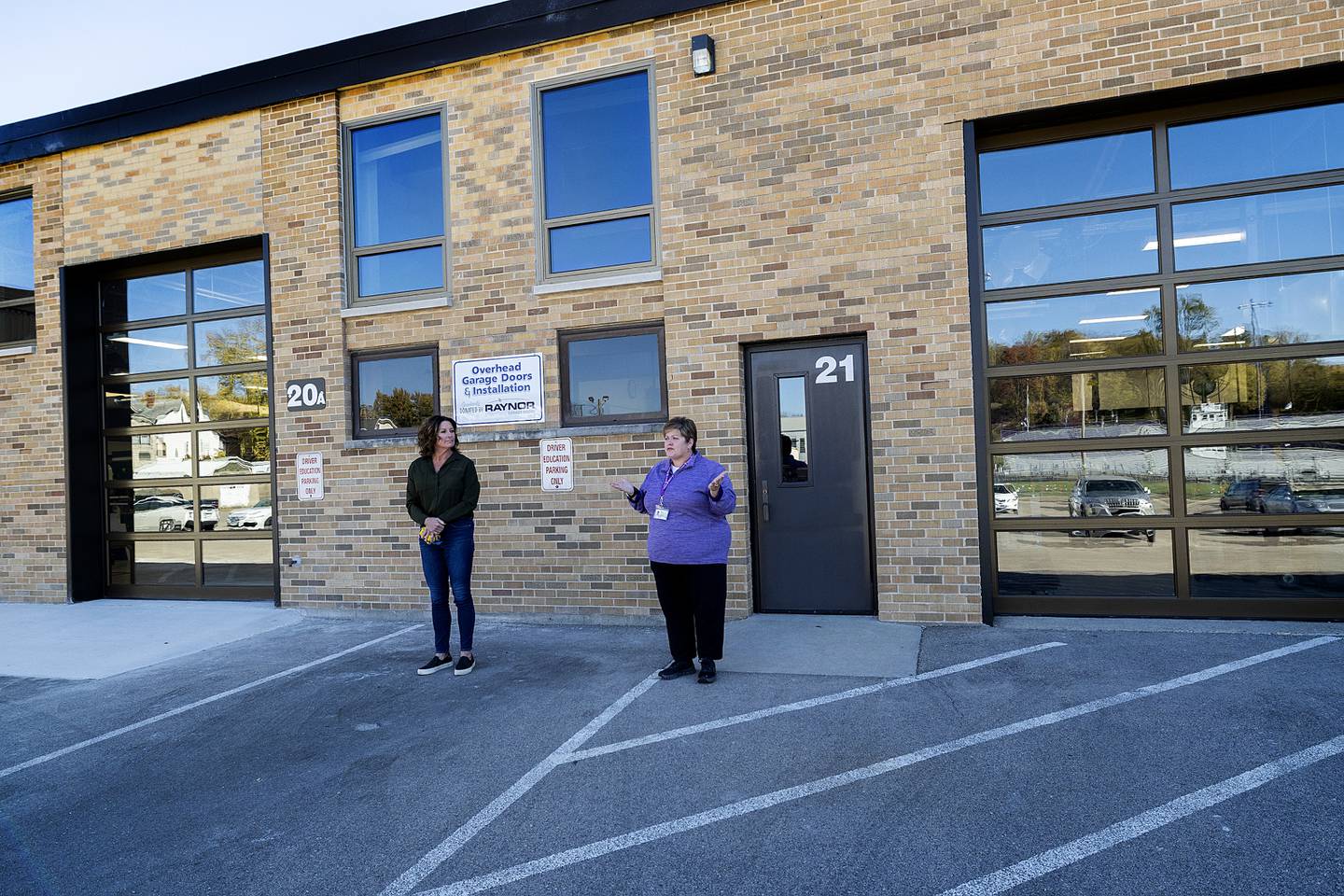 Raynor representative Mary Whelan (left) and Dixon Schools’ superintendent Margo Empen Saturday, Oct. 19, 2024, show off two new doors donated by Raynor at Dixon High School.