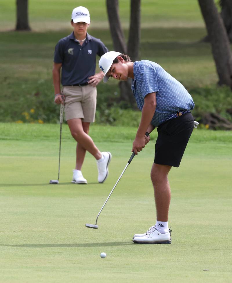 St. Charles North’s Jack Van Laningham putts as Sycamore’s Andrew Swedberg looks on Monday, Sept. 16, 2024, during the Mark Rolfing Cup at the Kishwaukee Country Club in DeKalb.