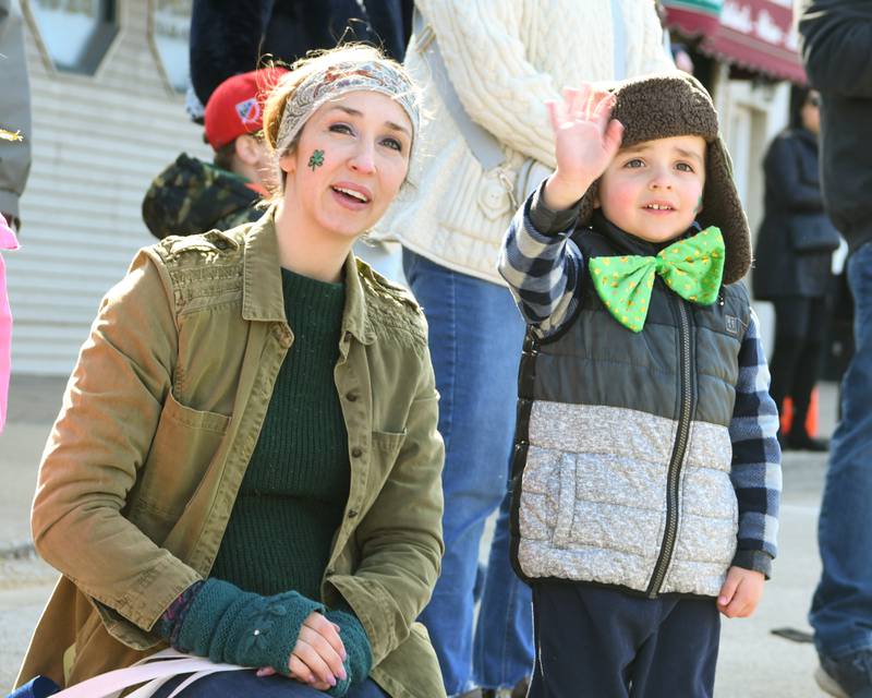On Saturday March 9, 2023, 3 ½ year old Than Hovaniec waves as the St. Patrick’s parade in downtown Lemont as his mom Mackenzie Hovaniec also look on.
