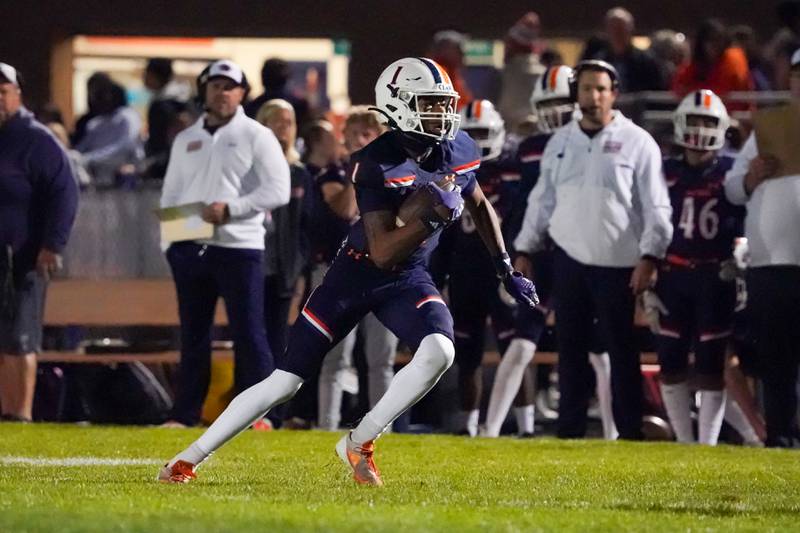 Oswego’s Jeremiah Cain (1) runs after the catch against Minooka during a football game at Oswego High School on Friday, October 18, 2024.