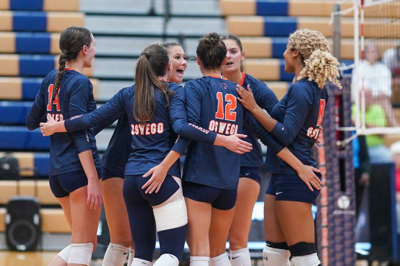 Oswego players celebrate their two set victory over Rosary at the end of a volleyball match at Oswego High School on Tuesday, Sep 3, 2024.