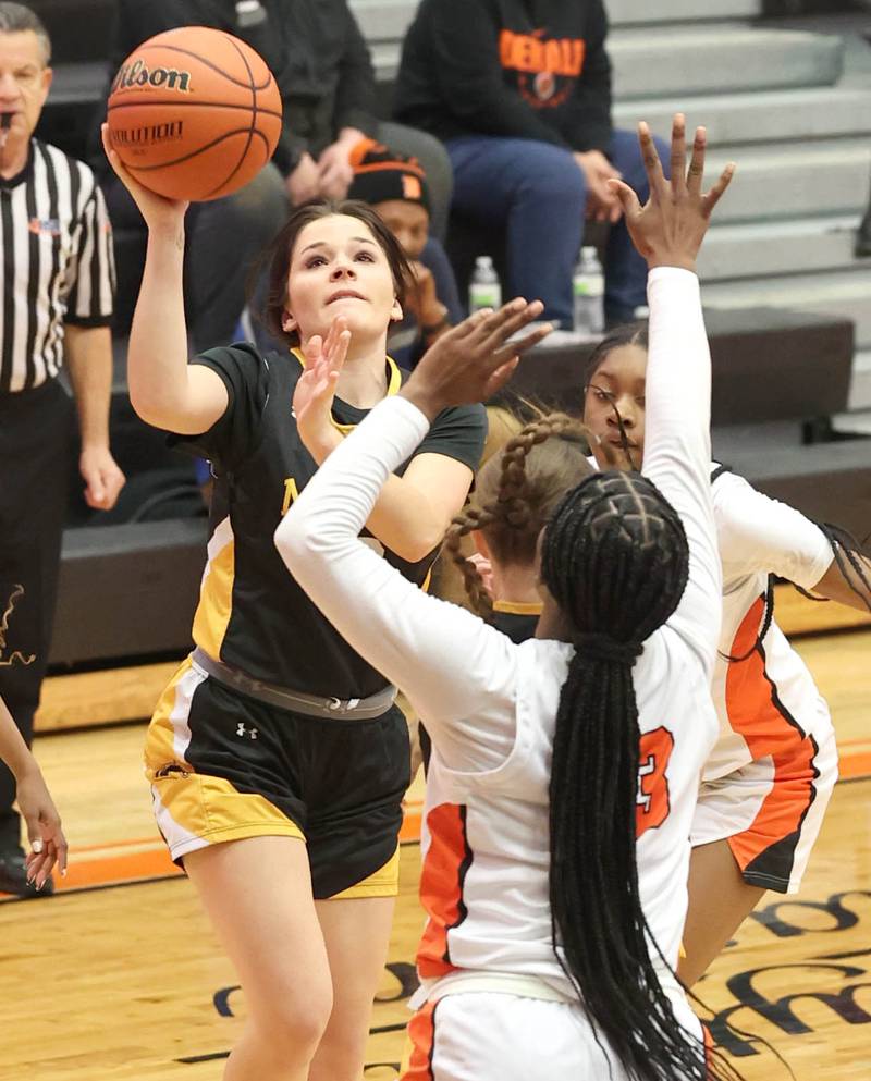 Metea Valley's Reese Valha shoots over a pair of DeKalb defenders during their game Friday, Jan. 19, 2024, at DeKalb High School.