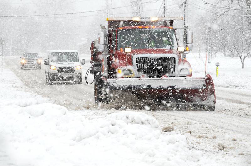 A Yorkville municipal plow pushes snow and applies salt on Game Farm Road during a major snowstorm in Yorkville on Tuesday, Jan. 9, 2023.