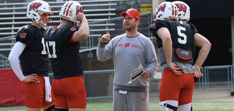 Wisconsin quarterbacks coach Jon Budmayr is leaving to become offensive coordinator at Colorado State. Budmayr is a 2009 Marian Central graduate.