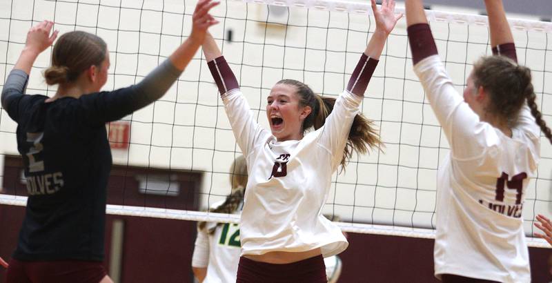 Prairie Ridge’s Adeline Grider, center, and the Wolves get revved up in their win over district rival Crystal Lake South in varsity girls volleyball on Thursday, Aug. 29, 2024, at Prairie Ridge High School in Crystal Lake.