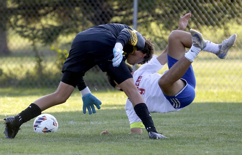 Crystal Lake South's Noah Dunteman tries to grab the ball as Dundee-Crown's Gabriel Herrera Jr. falls to the ground as they collide during a Fox Valley Conference soccer match on Tuesday, Sept. 10, 2024, at Crystal Lake South High School.