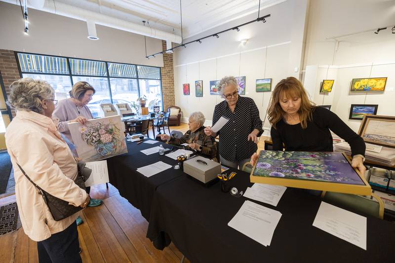 Phidian Art Club members Paula Sherman (right) and Ellen Allen check in a painting by Dixon artist Sheila Ames on Tuesday, April 2, 2024, at The Next Picture Show in Dixon. The 75th art show will take submissions on Wednesday, April 3, from 2-6 p.m. at the gallery. An opening will take place Friday, April 5, from 6-8 p.m. with awards starting at 7 p.m.