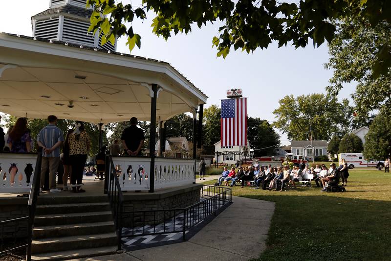 People listen to the McHenry High School choir perform during a Sept. 11 remembrance ceremony on Sept. 11, 2024, at Veteran's Memorial Park in McHenry.