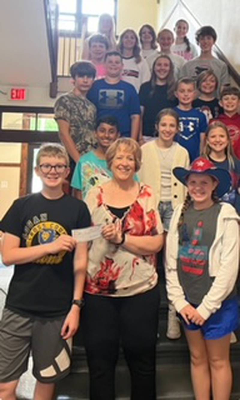 Princeton Logan Junior High Student Council gathers for a photo with Vanessa Hoffeditz, director of the Bureau County Food Pantry, after the group organized a fundraiser for the cause.