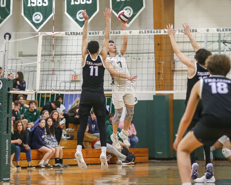 Glenbard West's Adam Graham (7) tips the ball over the net during volleyball match between Downers Grove North at Glenbard West.  April 2, 2024.