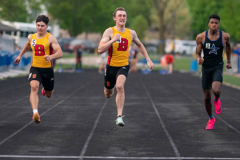 Batavia’s Weston White (center) finishes first in the 100 meter dash during a DuKane Conference boys track and field meet at Geneva High School on Thursday, May 11, 2023.