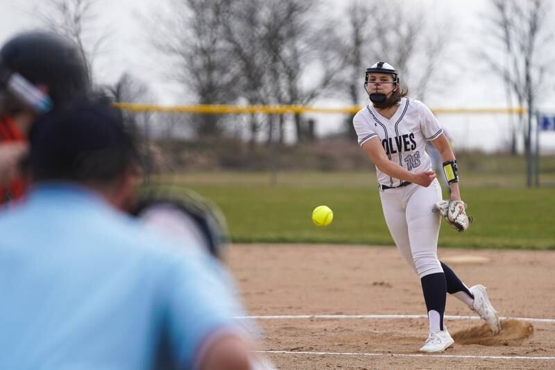 Oswego East's Nicole Stone (16) delivers a pitch against St. Charles East during a softball game at Oswego East High School on Wednesday, March 13, 2024.