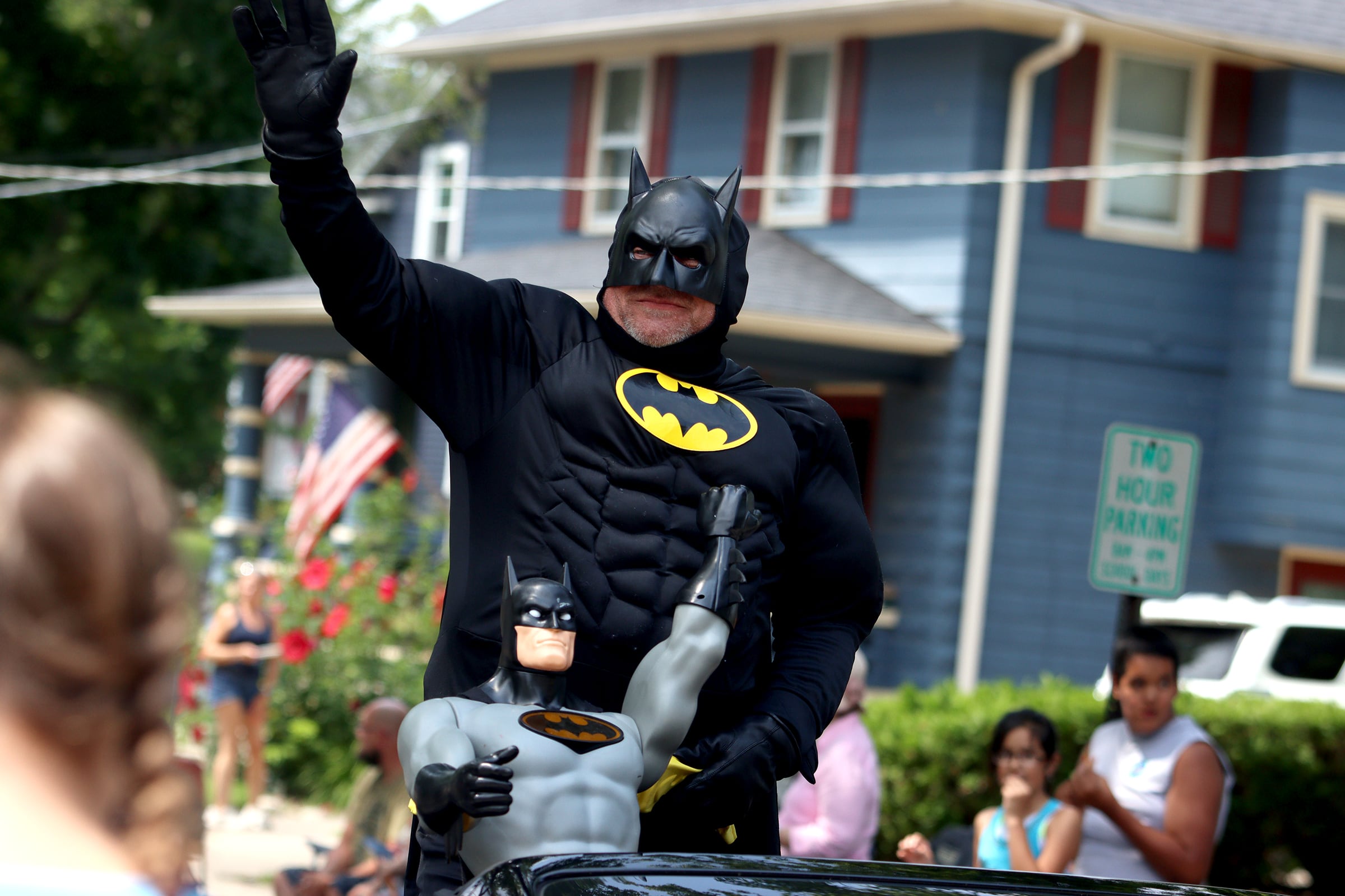 Batman greets people as part of the Fiesta Days parade along Main Street in McHenry Sunday.