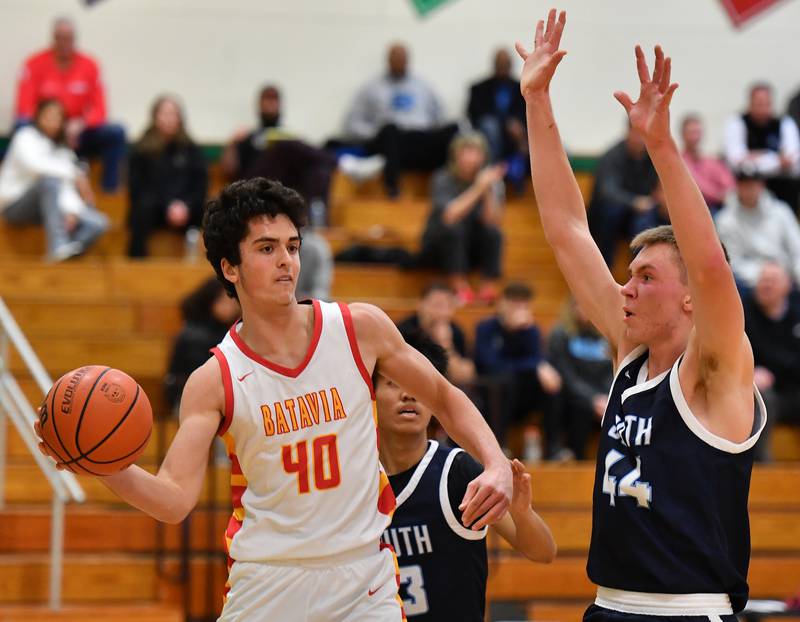 Batavia's C.J. Valente (40) passes as Justin Sveiteris defends during a Jack Tosh Classic game on Dec. 26, 2023 at York High School in Elmhurst.