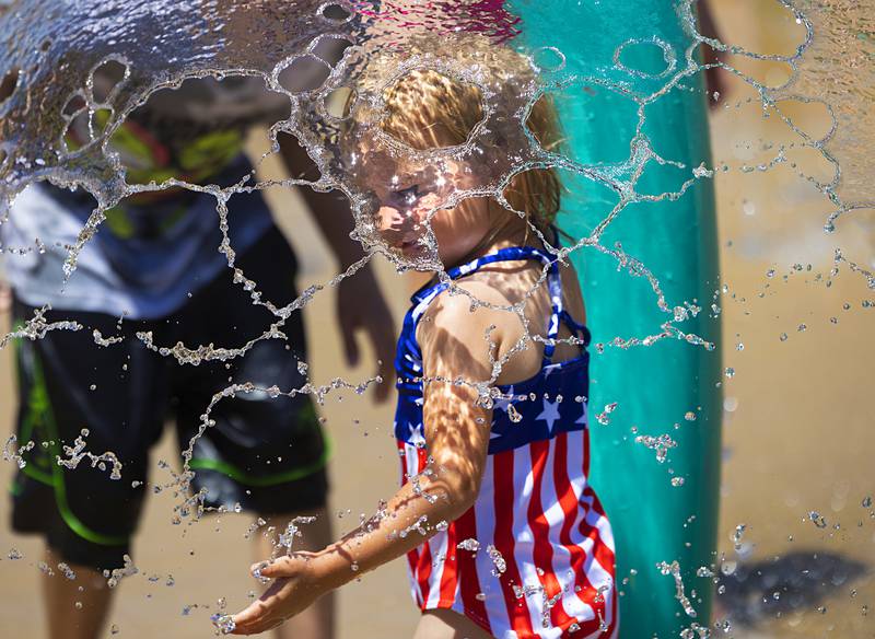 Cora Deter, 2, of Morrison plays in a cascade of water Wednesday, June 12, 2024 at the Dixon Park District splash pad. The pads and pools will be popular as a heat wave settles over the Sauk Valley.