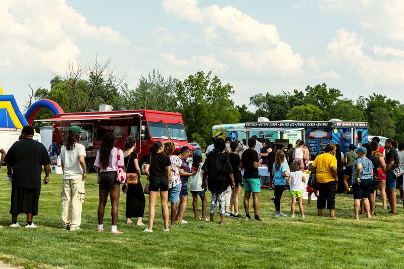 Attendees lineup at the food trucks during Lockport Township Park District's Juneteenth Celebration at A.F. Hill Park on June 19, 2024.