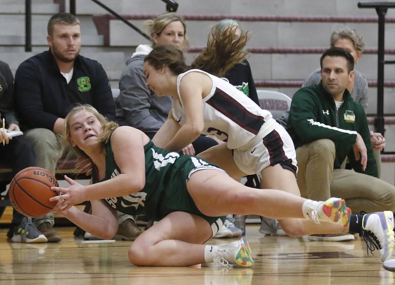 Crystal Lake South's Laken LePage passes the ball to a teammate as Prairie Ridge's Ali Storz tries to get the ball during a Fox Valley Conference girls basketball game Tuesday, Dec. 6, 2022, between Prairie Ridge and Crystal Lake South at Prairie Ridge High School.