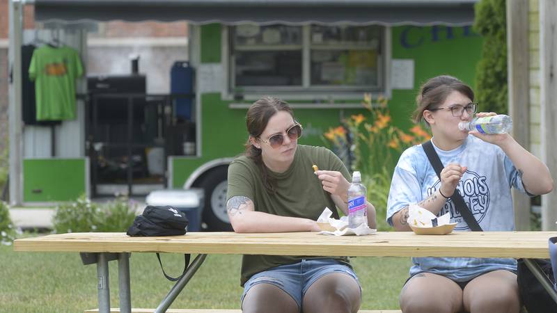 Emily Price and Julie Cummings enjoy their lunch at the Jordan Block after visiting the Infinity Food Truck Festival Saturday in Ottawa.