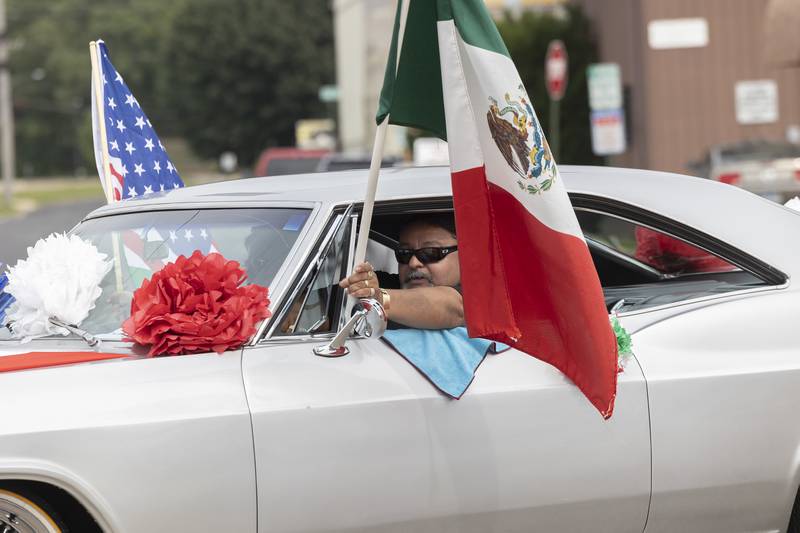 A group of lowriders cruise the streets during the Sauk Valley Fiesta Days parade Saturday, Sept. 16, 2023.