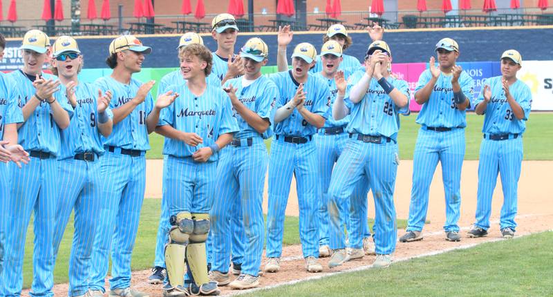Members of the Marquette baseball team applaud their teammates as they receive their medals after defeating Altamont to win the Class 1A State championship title on Saturday, June 1, 2024 at Dozer Park in Peoria.