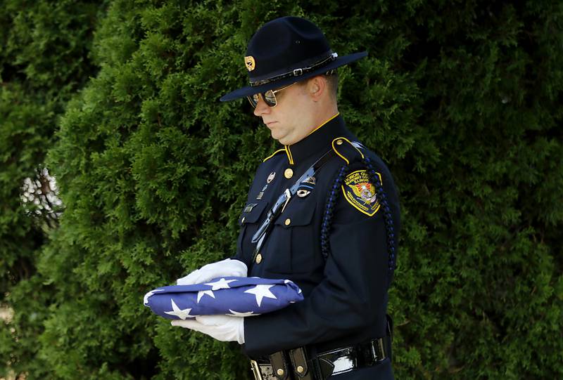 Algonquin police Sgt. James Sowizrol, with the McHenry County Chief of Police Honor Guard, holds the American flag during the moment of silence at a 9/11 remembrance ceremony on Sept. 11, 2024, at Veteran's Memorial Park in McHenry.