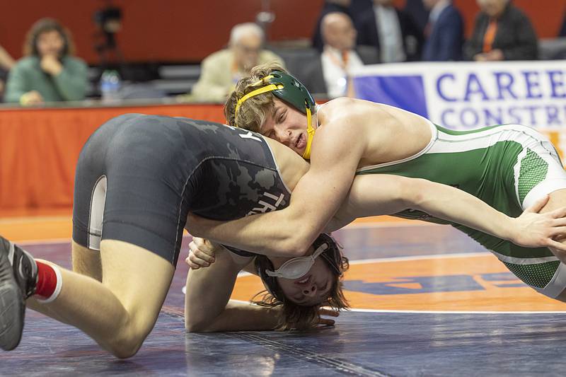 Coal City’s Landin Benson (top) grabs Tremont’s Bowden Delaney in the 1A 165 pound championship match Saturday, Feb. 17, 2024 at the IHSA state wrestling finals at the State Farm Center in Champaign.