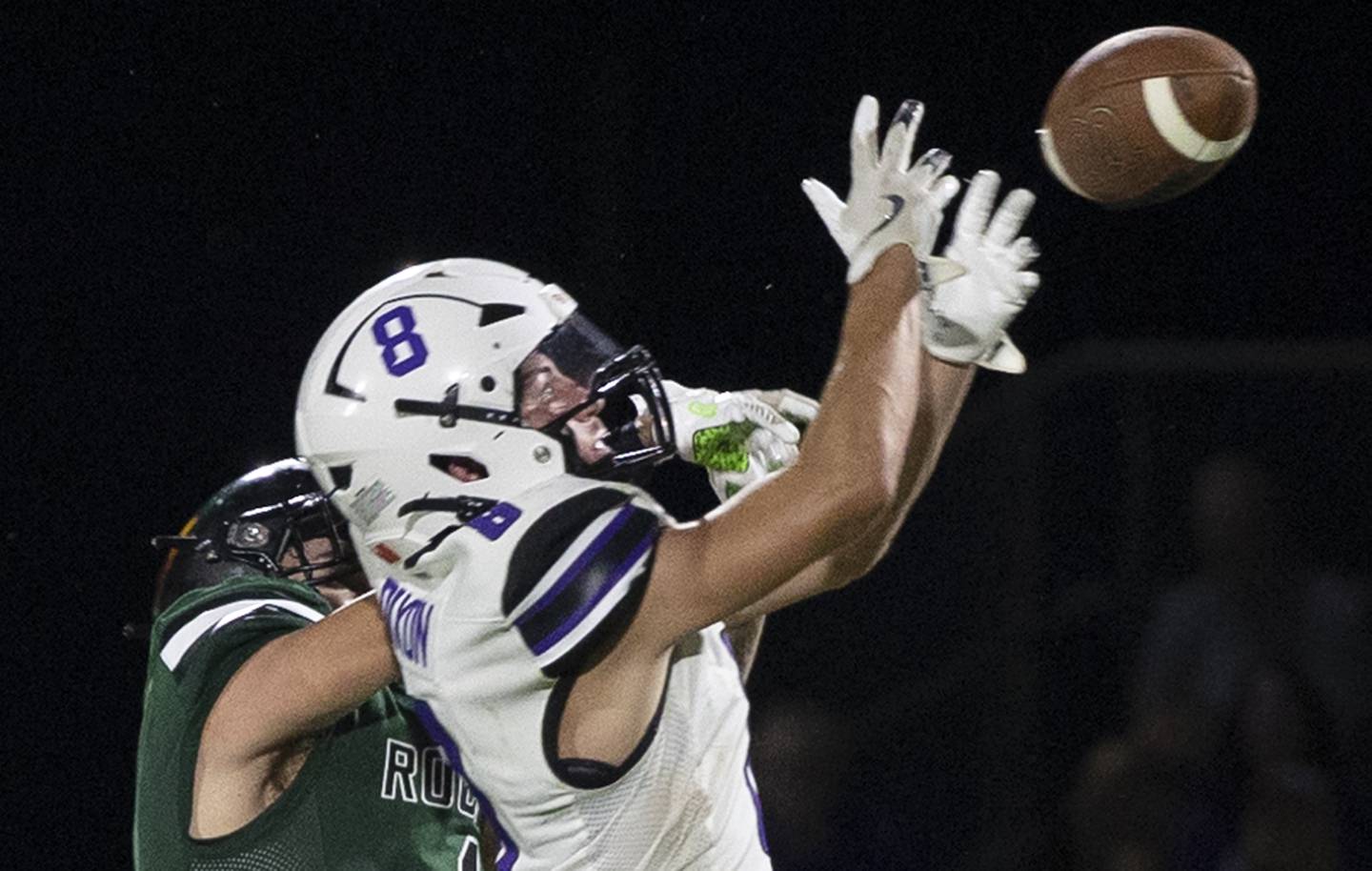 Dixon’s Tyson Dambman and Rock Falls’ Easton Canales go up for a pass Friday, Sept. 13, 2024, at Hinders Field in Rock Falls.