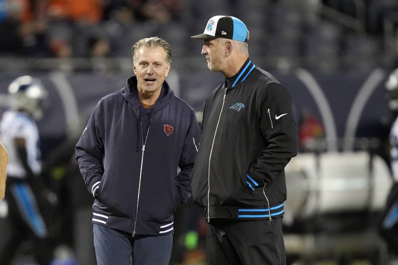 Chicago Bears head coach Matt Eberflus, left, talks to Carolina Panthers head coach Frank Reich, Thursday, Nov. 9, 2023, in Chicago.