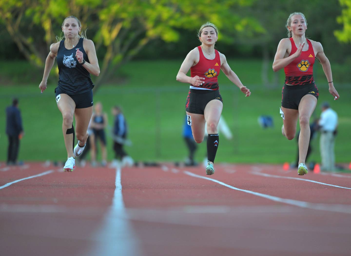 West Chicago’s Kali Waller, left, leads Batavia’s Taylor Isabelle and Elizabeth Wende, right, in the 100-meter dash at the Lake Park Class 3A girls track and field sectional meet on Friday, May 10, 2024. They finished first, fourth and second, respectively.