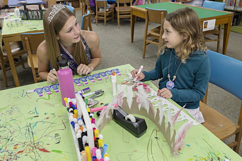 Petunia Queen Teyla Wendt and Ella Langenfeld , 6, discuss decorative ideas Wednesday, June 28, 2023 at the Dixon library. Petunia royalty started their busy week of fun and games with an afternoon of crafts.