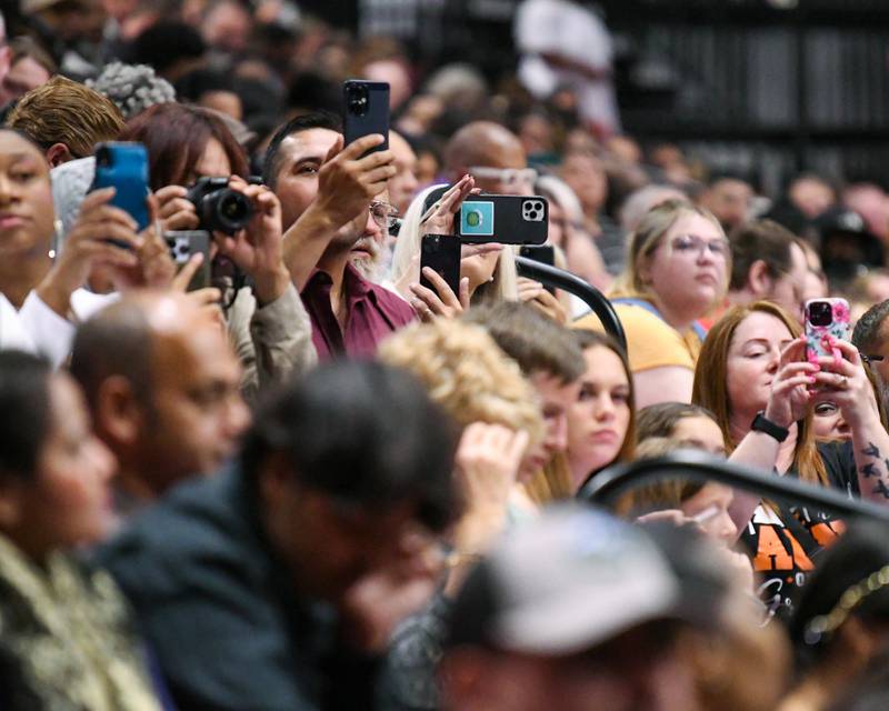 Friends and family capture special moments for their DeKalb High School graduates during the 2024 commencement ceremony on Saturday, May 25, 2024, at the Northern Illinois University Convocation Center in DeKalb.