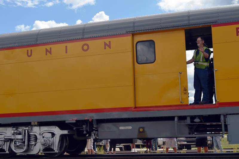 A Union Pacific employee that works on the Big Boy Steam Engine No. 4014 waves to onlookers as the train pulls out from its 15-minute whistle stop on Friday, Sept. 6, 2024, at the Sterling Marketplace.