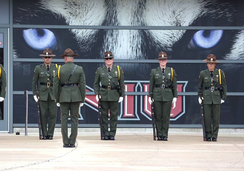 Illinois State Police officers prepare for a gun salute Thursday, April 4, 2024, following the visitation and funeral for DeKalb County Sheriff’s Deputy Christina Musil. Musil, 35, was killed March 28 while on duty after a truck rear-ended her police vehicle in Waterman.