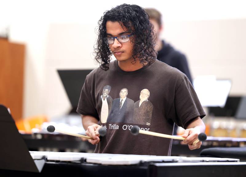 Jaden Teague-Núñez, 16, a sophomore at DeKalb High School, plays along with the percussion ensemble directed by Steve Lundin, the schools director of bands Monday, March 18, 2024, in the band room at the school. Teague-Núñez won first place in the Chicago Symphony Orchestra’s Young Artists Competition playing the steelpan and will appear as a soloist in a CSO youth concert during the 2024-25 season.