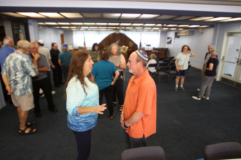 Congregation members visit as the McHenry County Jewish Congregation held a deconsecration ceremony at their Ridgefield Road location in preparation for a move to the Tree of Life Unitarian Church in McHenry on Sunday, August 18.