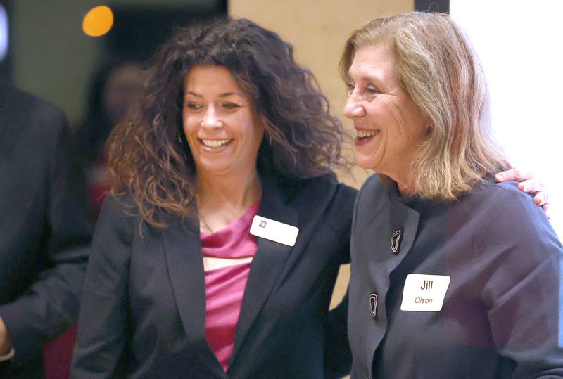 Jill Olson, (right) with CASA DeKalb County, hugs Board Chair Tia Anderson after CASA was presented with the 2023 Nonprofit Organization Award Thursday, Feb. 9, 2023, during the DeKalb Chamber of Commerce’s Annual Celebration Dinner in the Barsema Alumni and Visitors Center at Northern Illinois University.