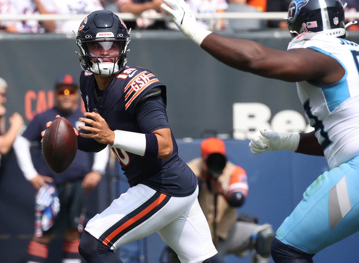 Chicago Bears quarterback Caleb Williams avoids the pressure of Tennessee Titans defensive tackle Sebastian Joseph-Day during their game Sunday, Sept. 8, 2024, at Soldier Field in Chicago.