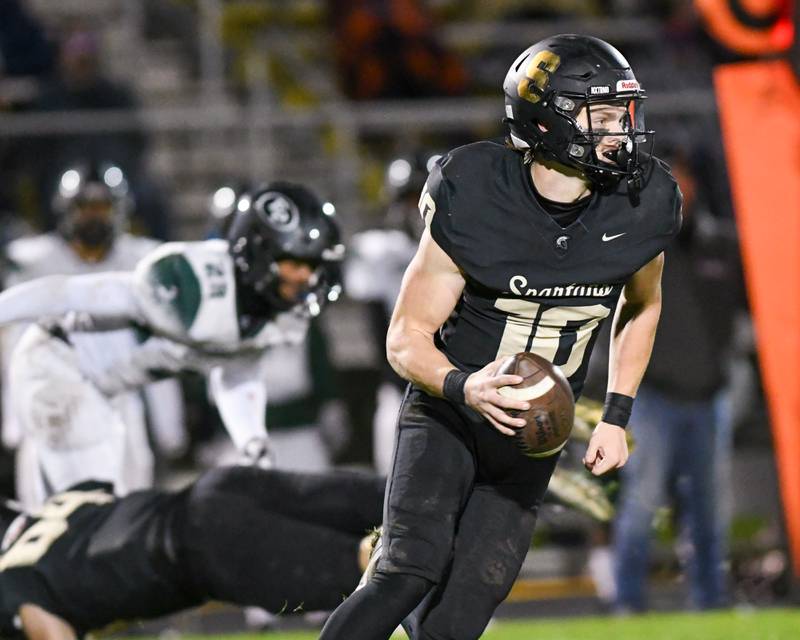 Sycamore Burke Gautcher (10) runs the ball during the second quarter before being pushed out of bounds by an Evergreen Park defender on Friday Oct. 27, 2023, held at Sycamore High School.