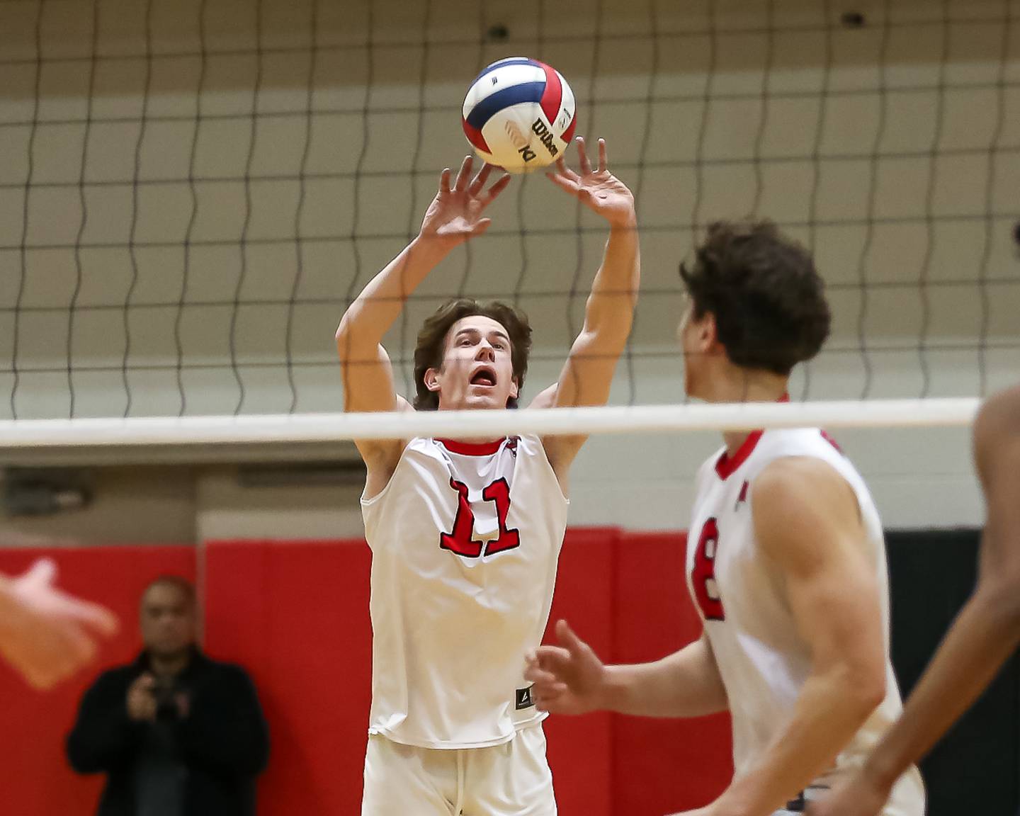 Bolingbrook's Connor Dmochowski (11) sets a shot during volleyball match between Neuqua Valley at Bolingbrook.  April 1, 2024.