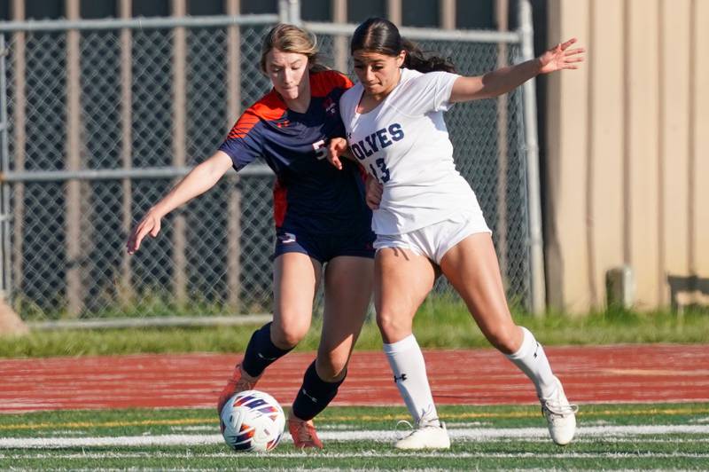 Oswego East's Jocelyn Cruz (13) challenges Oswego’s Aubrey Eirich (5) for the ball during a Class 3A Lockport Regional semifinal soccer match at Lockport High School in Lockport on Wednesday, May 15, 2024.