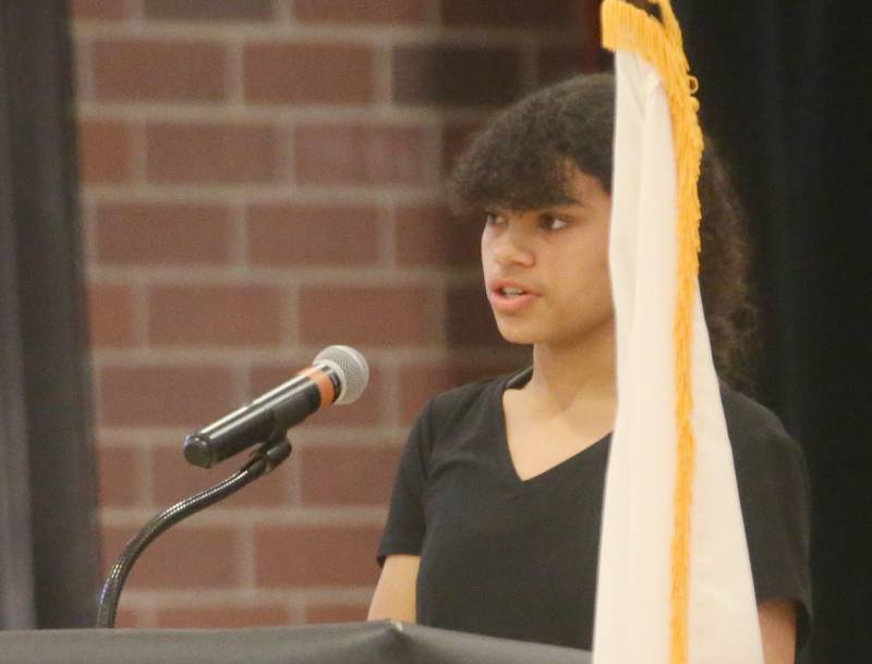 Student Jazmine Adams reads her poem "Away" during the Parkside School Veterans Day Program on Friday, Nov. 10, 2023 at Parkside Middle School in Peru.