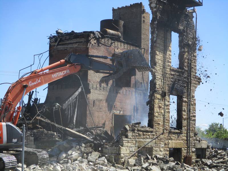 A wrecking machine on Saturday tears down the limestone exterior of the old U.S. Steel Main Office Building at 927 Collins St. in Joliet after a devastating fire that was reported at 3:11 a.m. Sept. 7, 2024