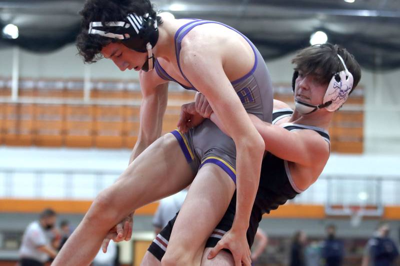 Prairie Ridge’s Mikey Meade, right, throws Wauconda’s Cooper Daun in the 126-pound title bout during IHSA Class 2A regional wrestling at Crystal Lake Central Saturday.